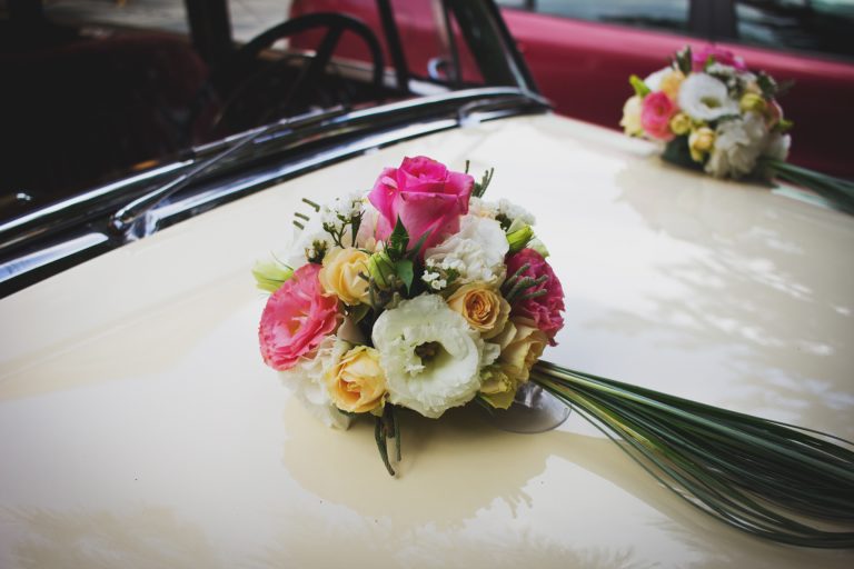 pink-green-and-white-flower-bouquet-on-beige-car-129065